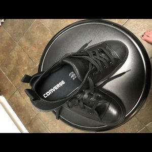 Black all leather converse tennis shoes.